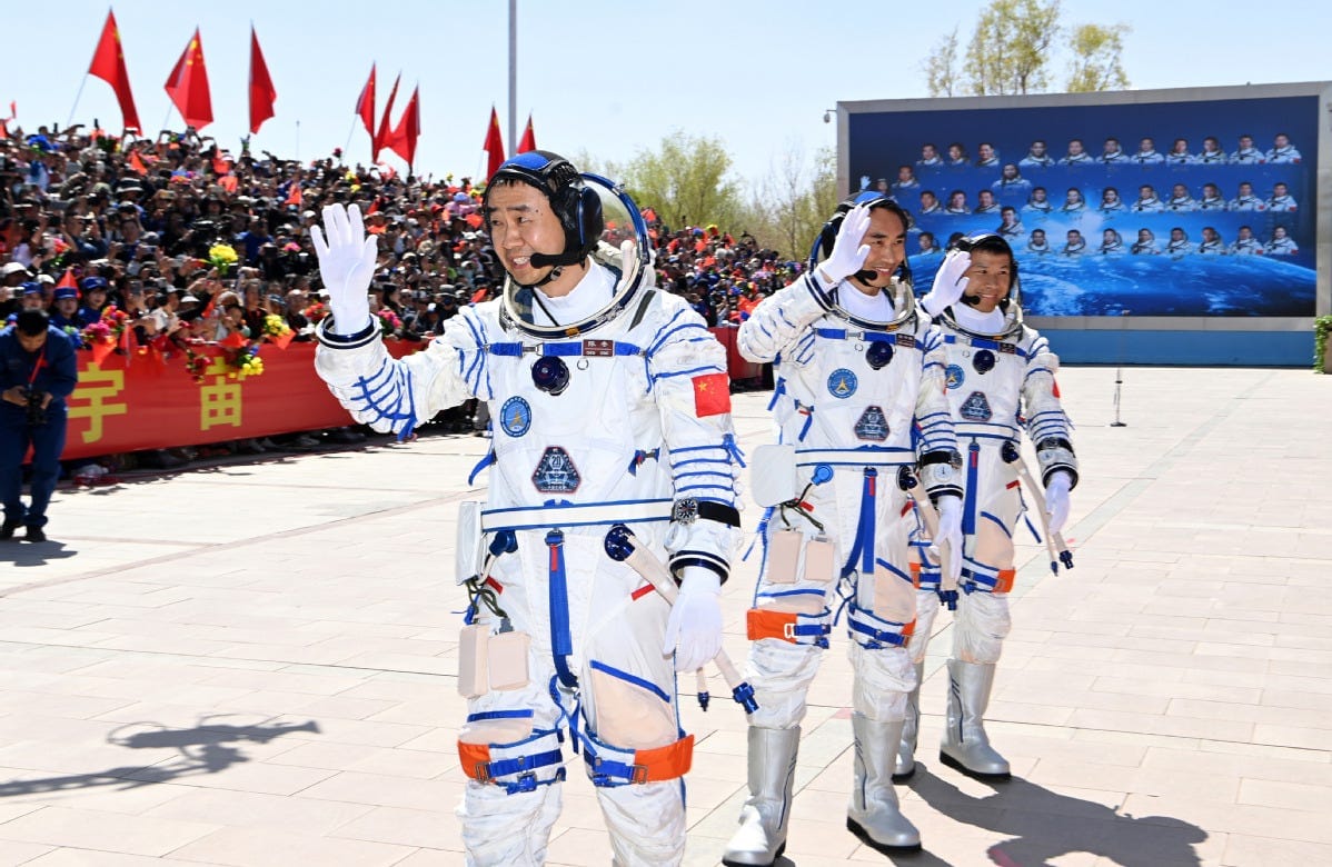 Taikonauts Chen Dong (left), Chen Zhongrui (center), and Wang Jie (right) photographed before the Shenzhou‑20 launch in April 2025.