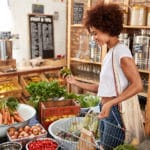 Woman Buying Fresh Fruit And Vegetables In Sustainable Plastic F