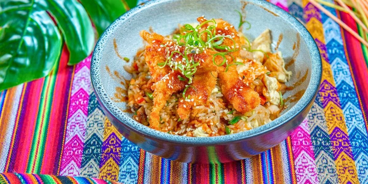 a plate of rice on a brightly colored tablecloth
