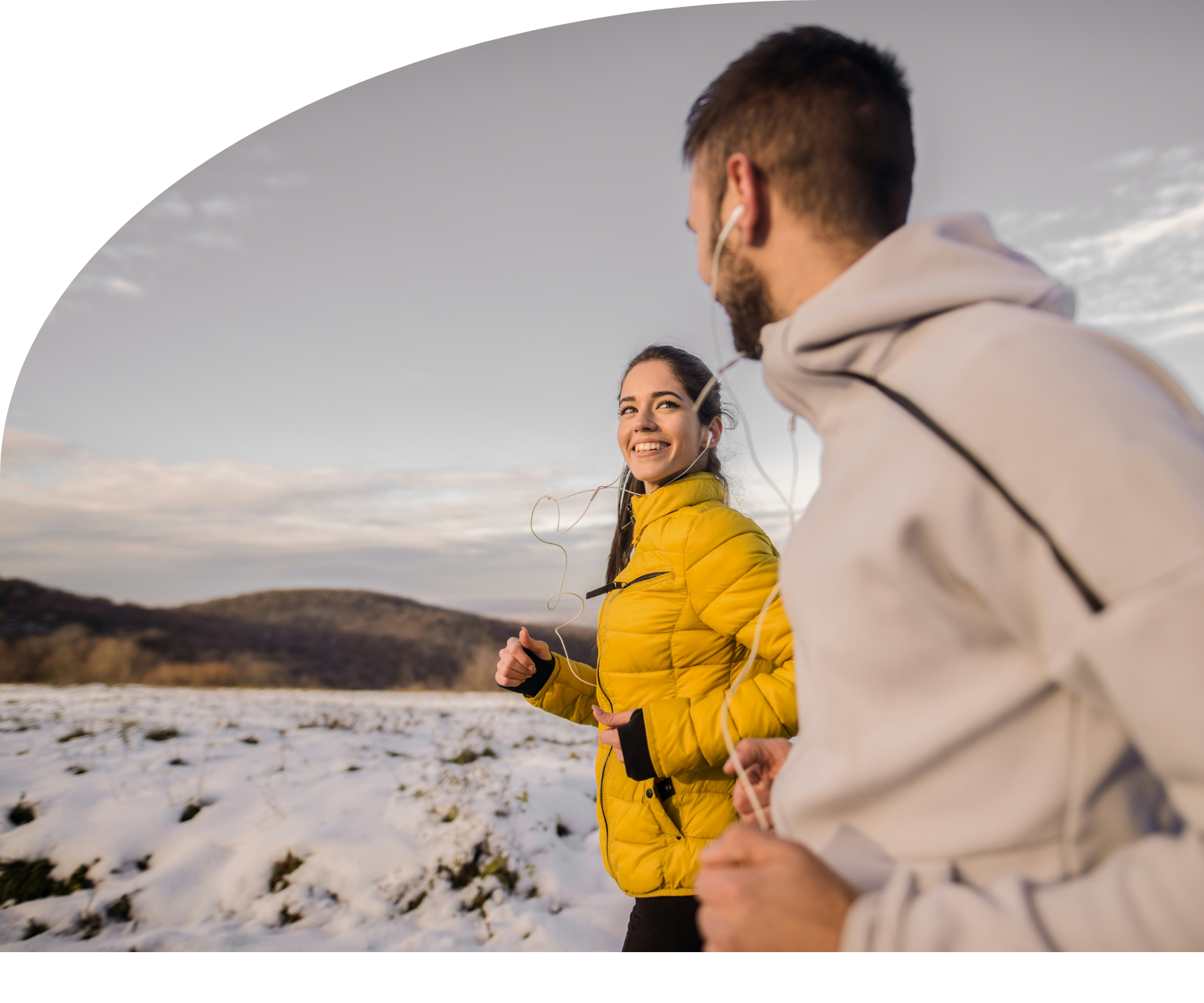 Two people are walking in the snow