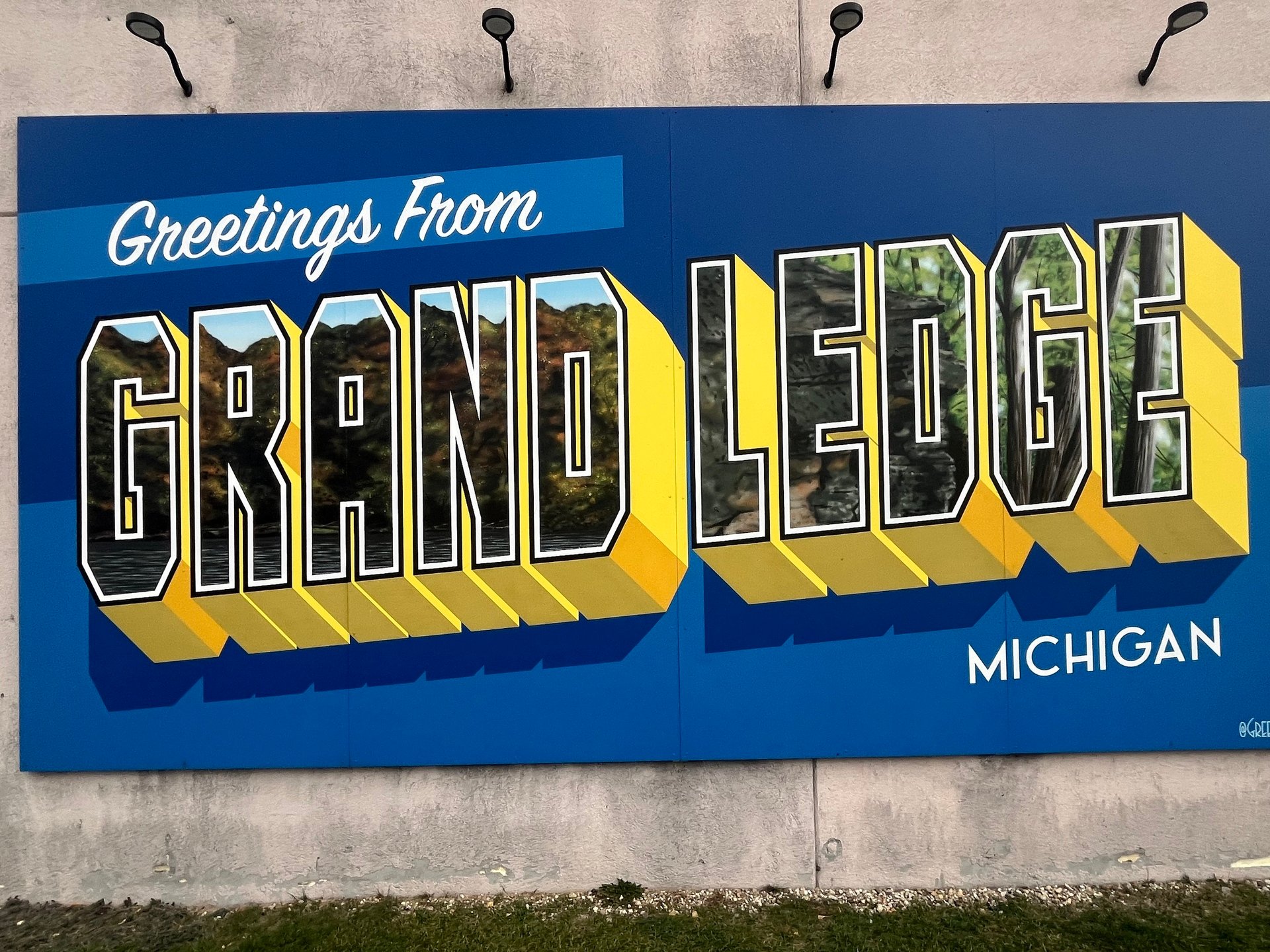 City Workers Raise Holiday Tree as Grand Ledge Prepares for Parade, Showcases Bridge Street Landmarks, and Features a Pleasant Street Home for Sale