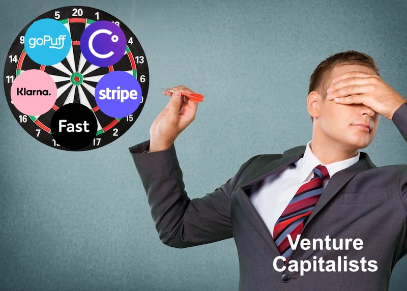A man in a suit throwing a dart at a dartboard while covering his eyes.