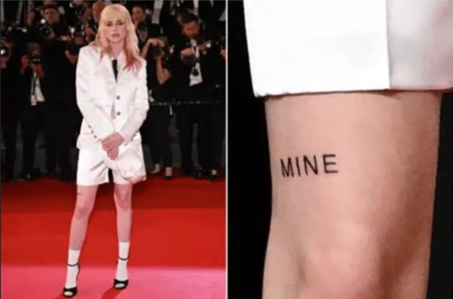 She tattooed "MINE" across her thigh