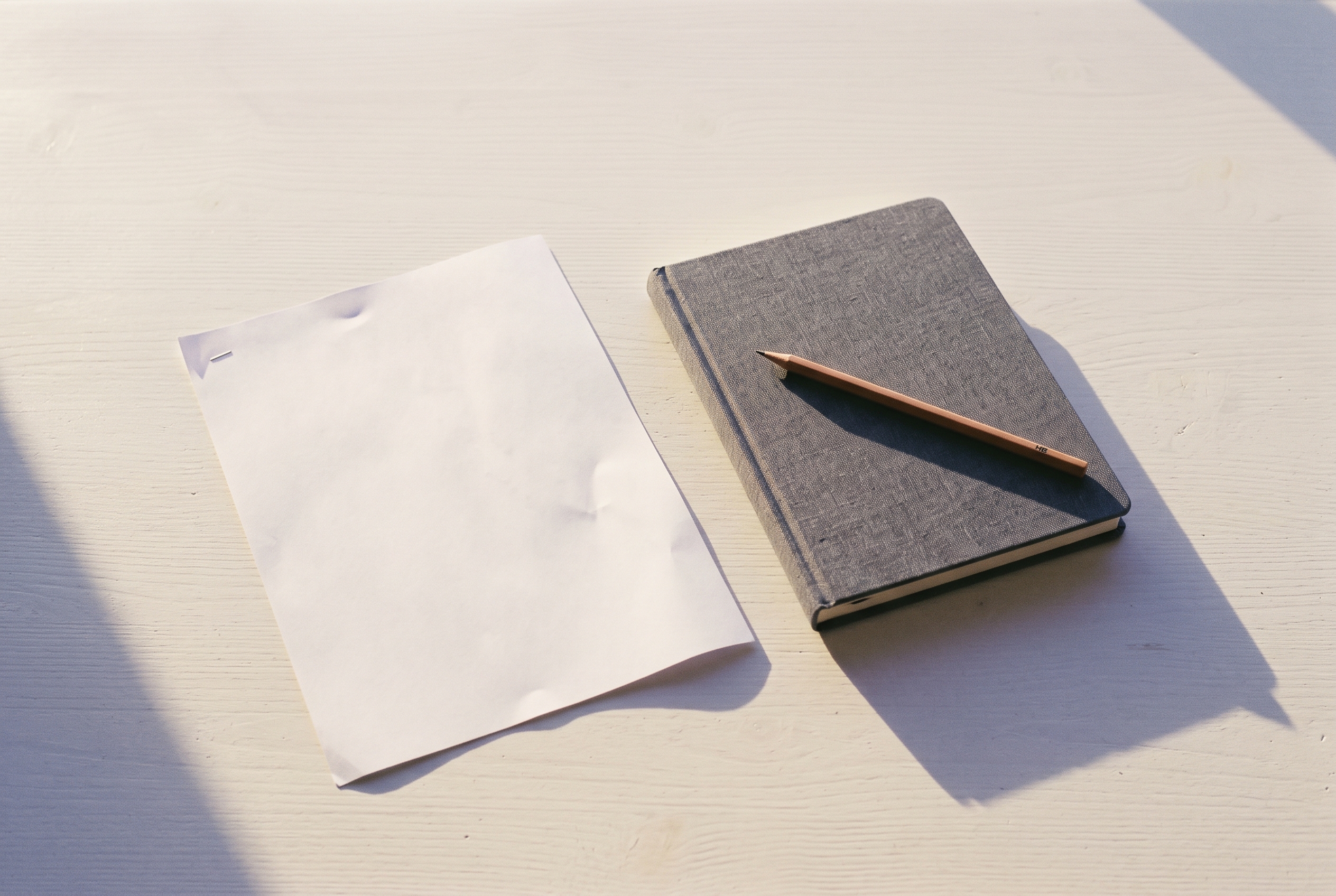 A closed notebook and a pencil at the end of a working day